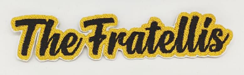 Toppa ricamata scritta corsivo nera contorno oro The Fratellis su sfondo bianco